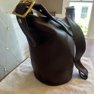 Brand new Coach bucket bag.  Never used.  Chocolate brown.  Brass hardware.